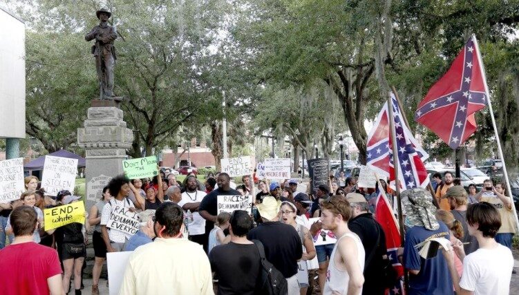 A group of anti-racist protestors confron a group of white supremacists.